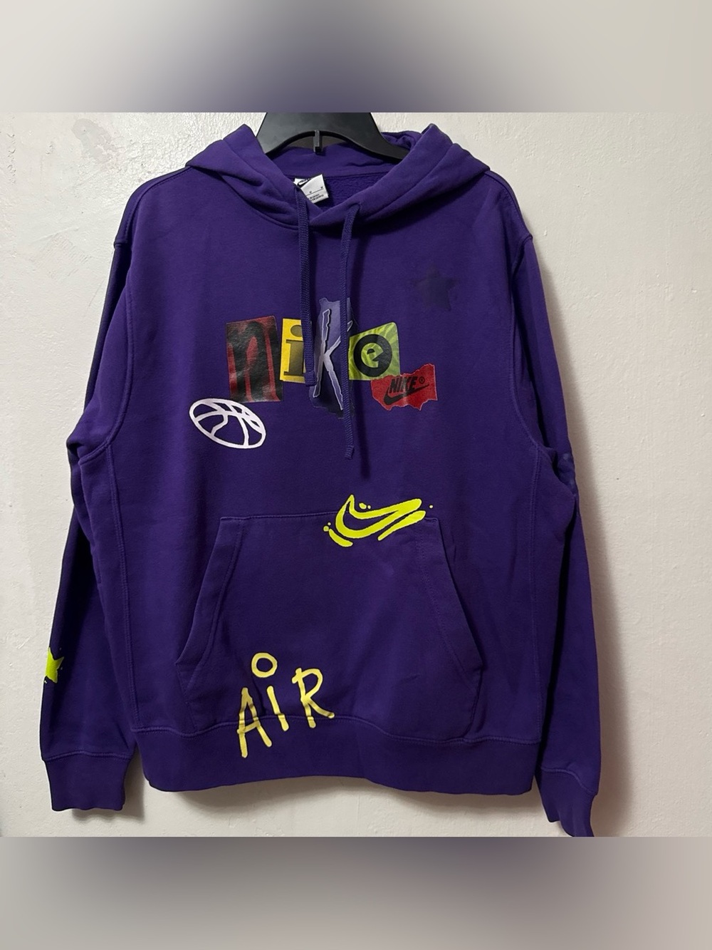 Nike Air purple hoodie with yellow 'AIR' text and various Nike logos and graphic